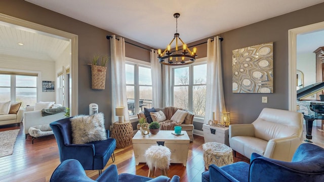 living area featuring wood-type flooring and an inviting chandelier