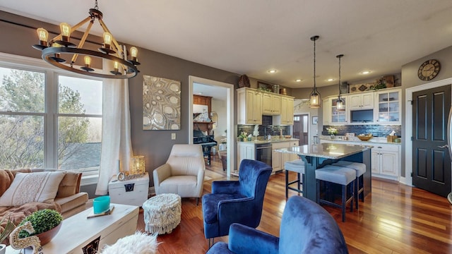 living room with recessed lighting, hardwood / wood-style flooring, and a notable chandelier