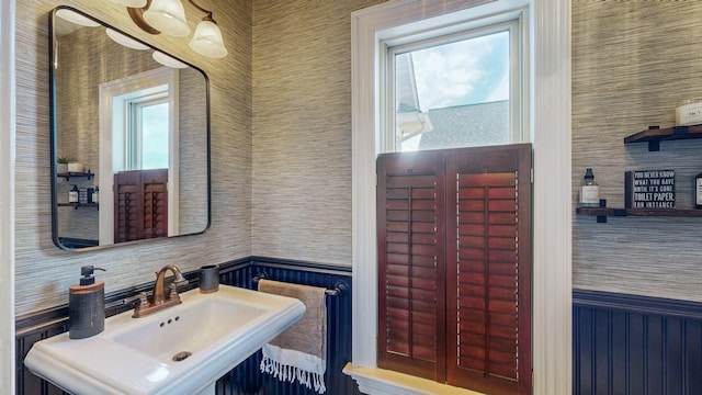 bathroom with wainscoting and a sink