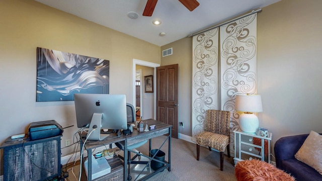 office featuring carpet floors, visible vents, baseboards, and a ceiling fan