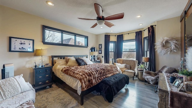 bedroom featuring ceiling fan, a textured ceiling, wood finished floors, and recessed lighting