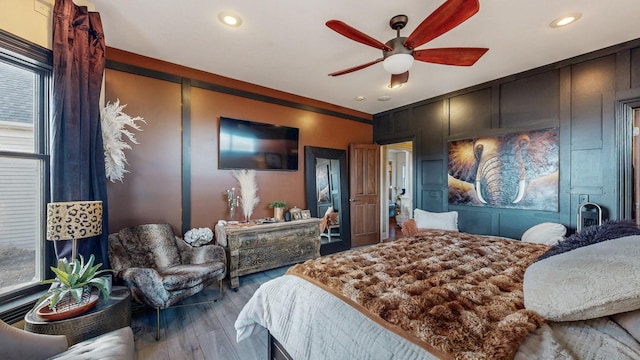 bedroom featuring multiple windows, wood finished floors, and recessed lighting