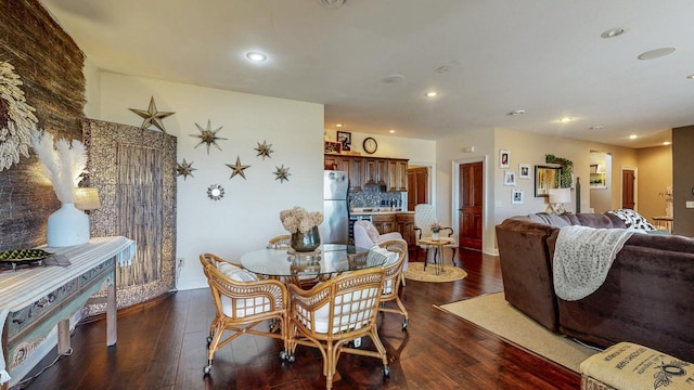 dining area with baseboards, dark wood-type flooring, and recessed lighting