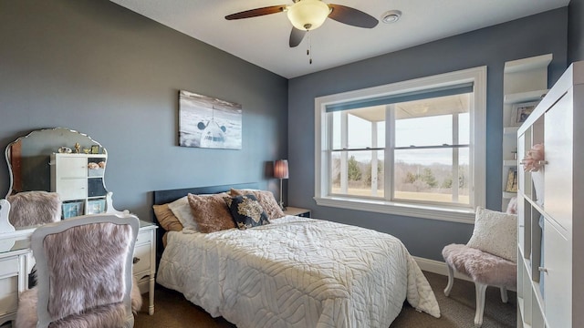 carpeted bedroom featuring ceiling fan and baseboards