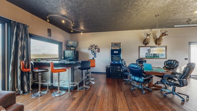 home office featuring a dry bar and wood finished floors