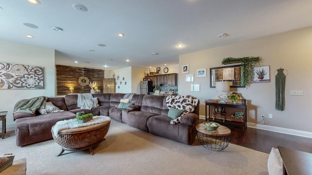 living area featuring carpet floors, wood finished floors, baseboards, and recessed lighting