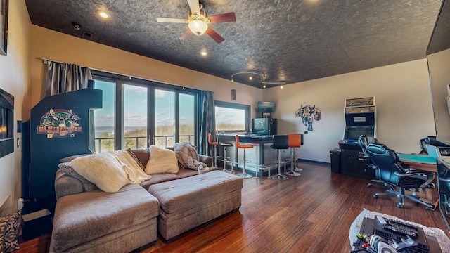 living room with ceiling fan and wood finished floors