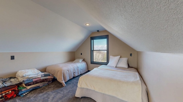 carpeted bedroom with a textured ceiling and lofted ceiling