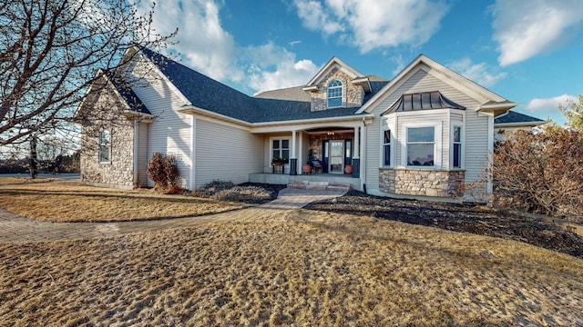 view of front of home featuring stone siding and covered porch