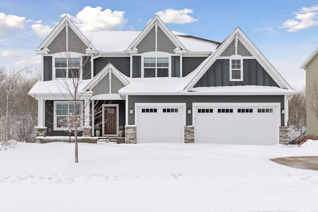 craftsman-style house featuring stone siding, board and batten siding, and an attached garage