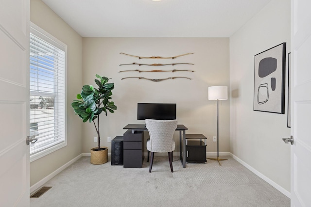 carpeted home office with visible vents and baseboards