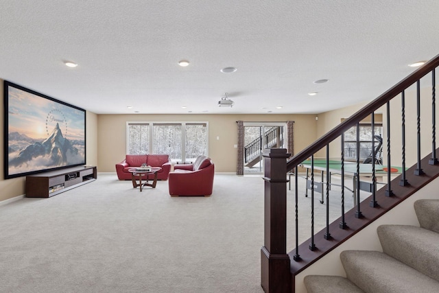 interior space featuring carpet floors, a textured ceiling, and baseboards