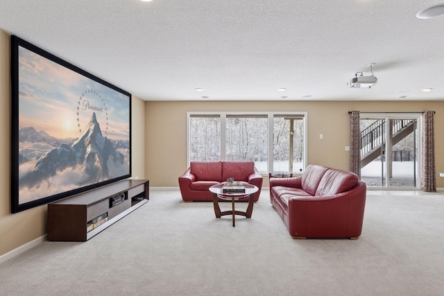 carpeted living area featuring a textured ceiling, recessed lighting, and baseboards