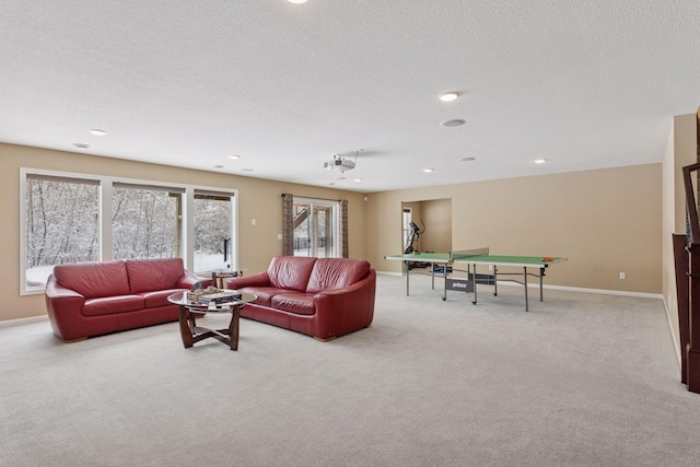 living area with recessed lighting, carpet flooring, a textured ceiling, and baseboards