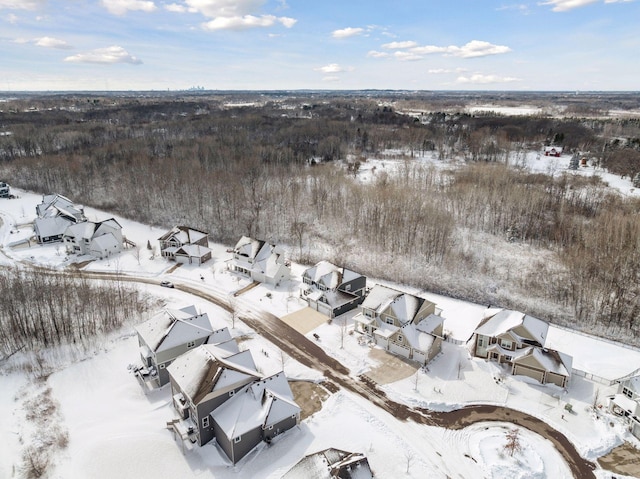 snowy aerial view with a residential view