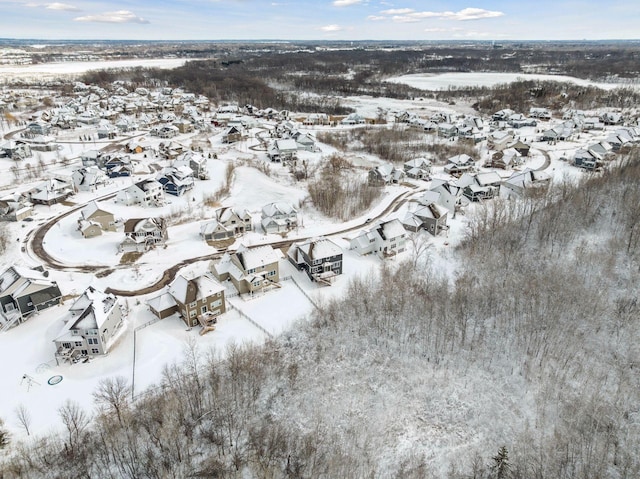 snowy aerial view with a residential view