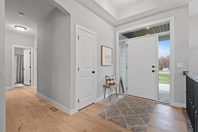 22816 Jarvis St NW, Elk River, MN 55330 - foyer entrance featuring a textured ceiling and light hardwood / wood-style floors