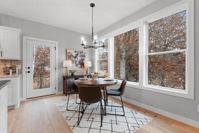 22816 Jarvis St NW, Elk River, MN 55330 - dining space with light hardwood / wood-style flooring and a notable chandelier