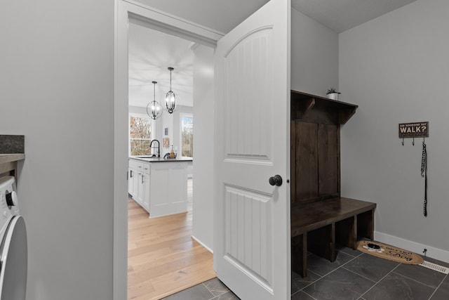 22816 Jarvis St NW, Elk River, MN 55330 - clothes washing area featuring washer / dryer, sink, a notable chandelier, and dark hardwood / wood-style floors