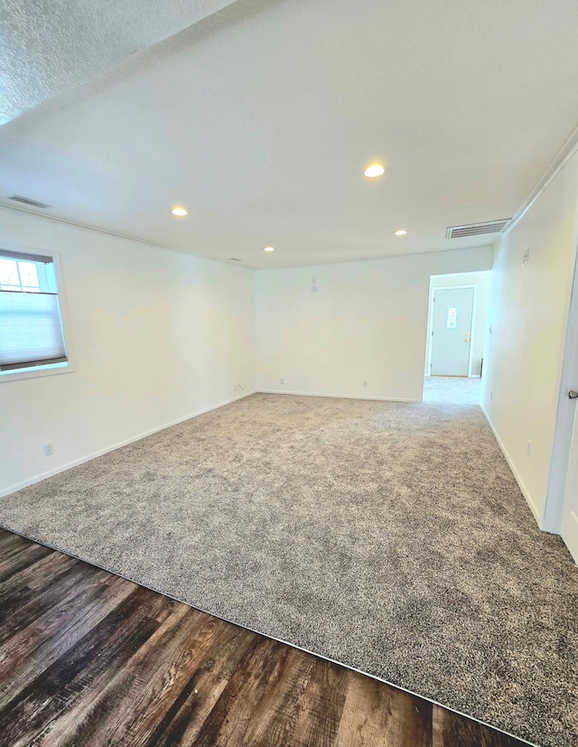 spare room with wood-type flooring