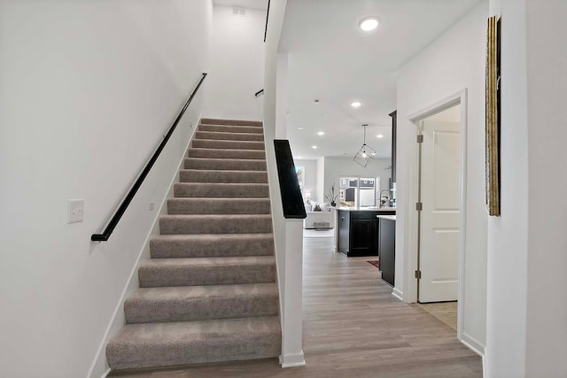 stairway featuring hardwood / wood-style floors