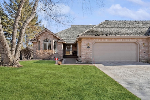 view of front facade with brick siding, driveway, an attached garage, and a front lawn