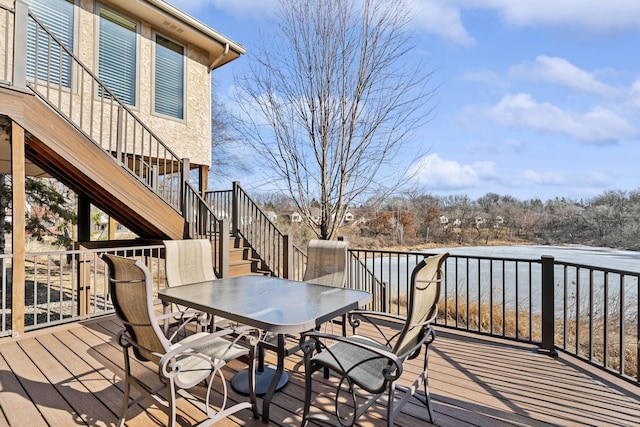 deck featuring stairway and outdoor dining area