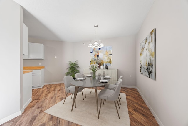 6615 Lake Shore Dr S Unit 311, Richfield, MN 55423 - dining space featuring light wood-type flooring and a chandelier