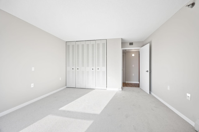 6615 Lake Shore Dr S Unit 311, Richfield, MN 55423 - unfurnished bedroom featuring light carpet and a closet