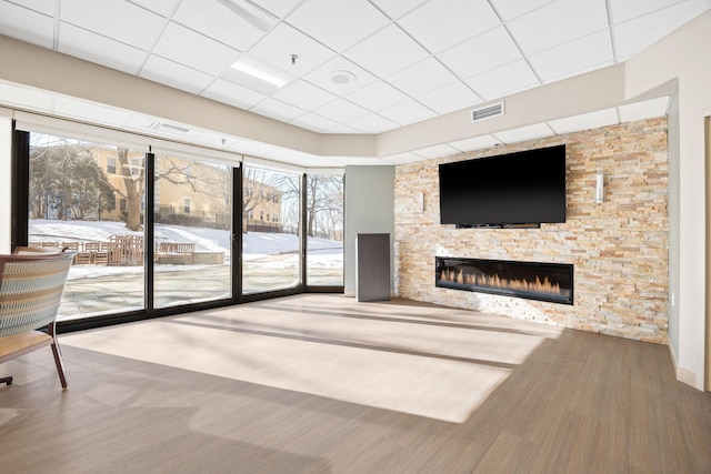 6615 Lake Shore Dr S Unit 311, Richfield, MN 55423 - unfurnished living room featuring a stone fireplace, healthy amount of natural light, and a paneled ceiling