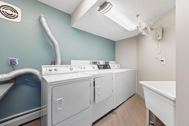 6615 Lake Shore Dr S Unit 311, Richfield, MN 55423 - washroom with washing machine and clothes dryer, a textured ceiling, and light wood finished floors
