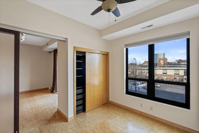 unfurnished bedroom with a closet and ceiling fan