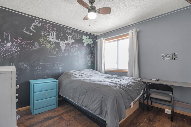 bedroom with baseboards, a textured ceiling, ceiling fan, and wood finished floors