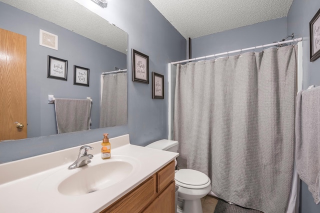 bathroom featuring visible vents, toilet, vanity, a shower with curtain, and a textured ceiling