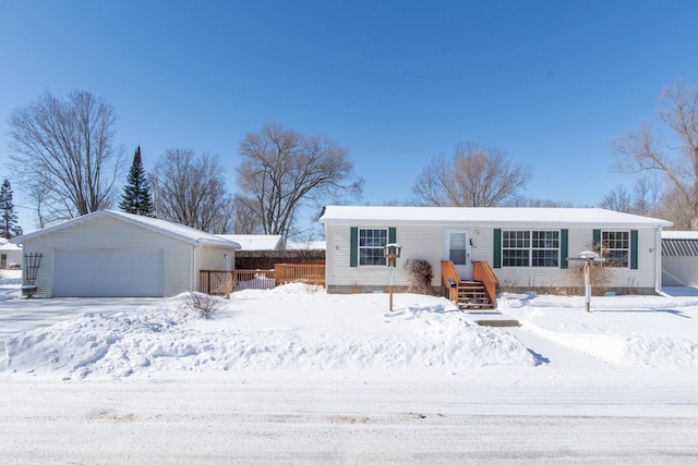 view of front of property with a detached garage and an outdoor structure