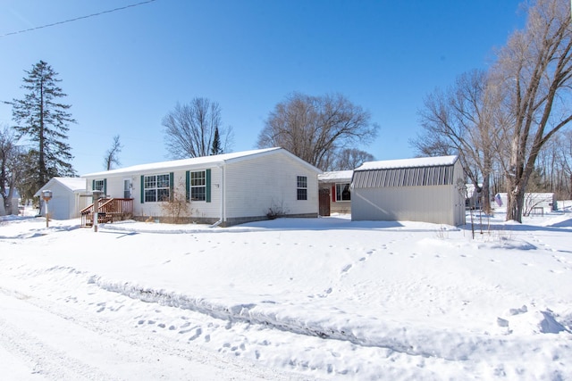 view of front facade featuring a garage and an outbuilding