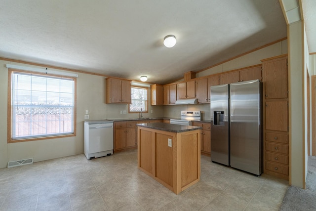 kitchen featuring under cabinet range hood, visible vents, appliances with stainless steel finishes, a center island, and dark countertops