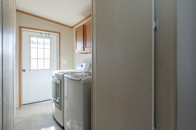 laundry area with independent washer and dryer, cabinet space, and crown molding