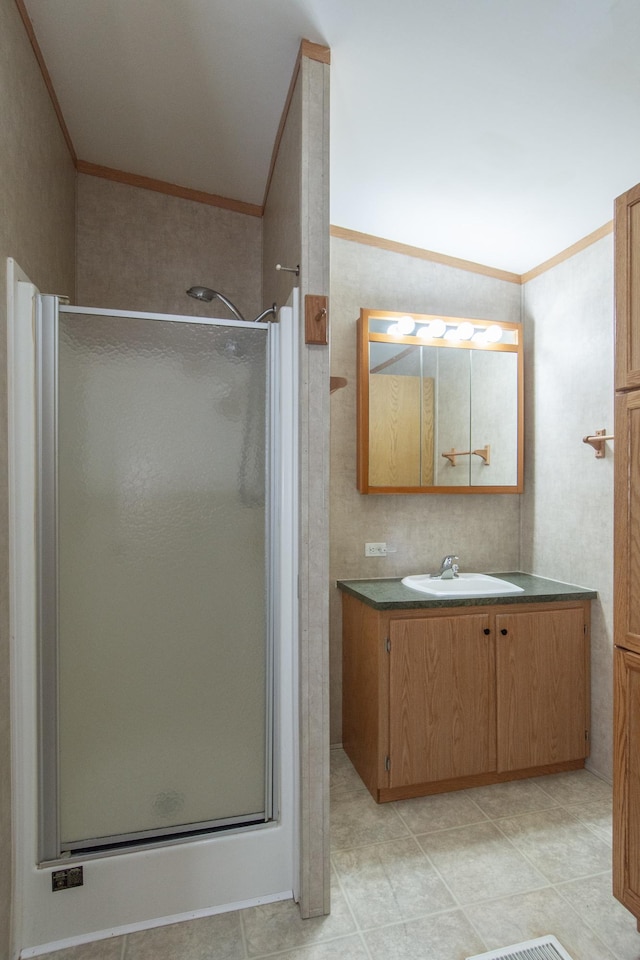 bathroom with a stall shower, vaulted ceiling, crown molding, and vanity