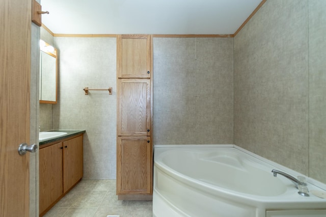 full bathroom featuring tile patterned flooring, a bath, and vanity