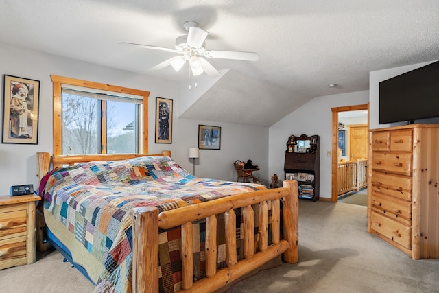 carpeted bedroom featuring ceiling fan, vaulted ceiling, and a textured ceiling