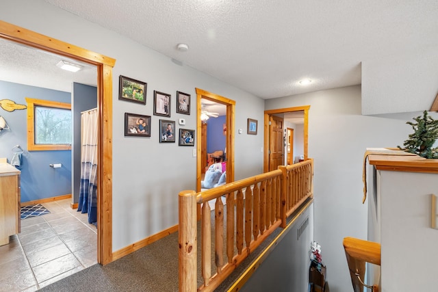 hall with a textured ceiling