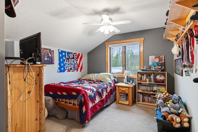 bedroom featuring ceiling fan, vaulted ceiling, carpet floors, and a textured ceiling