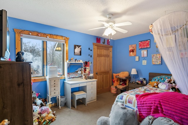 bedroom with ceiling fan, light carpet, and a textured ceiling