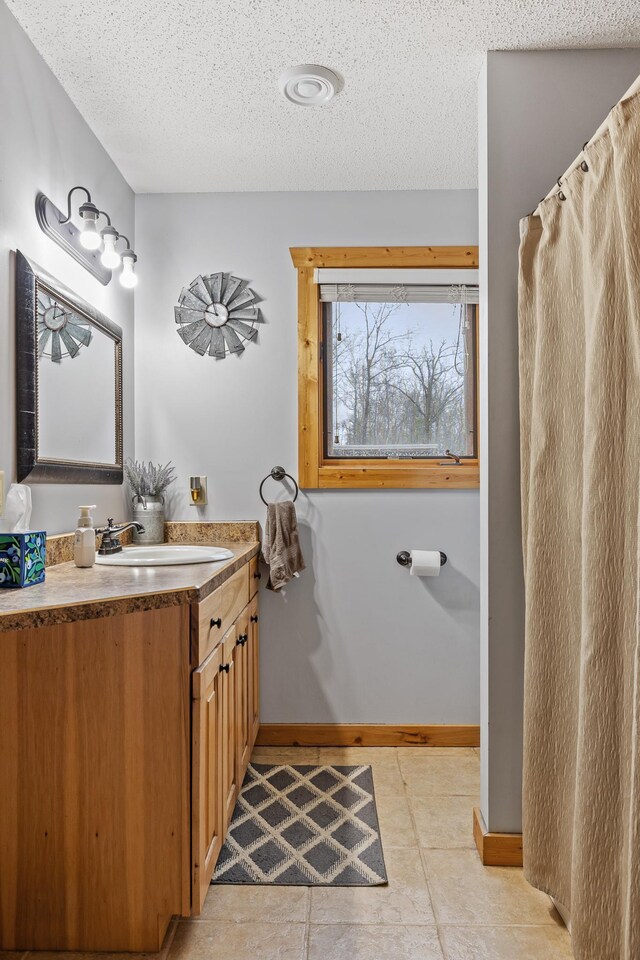 bathroom featuring a textured ceiling and vanity