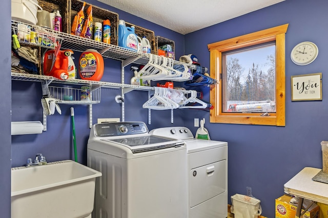 clothes washing area with sink and separate washer and dryer