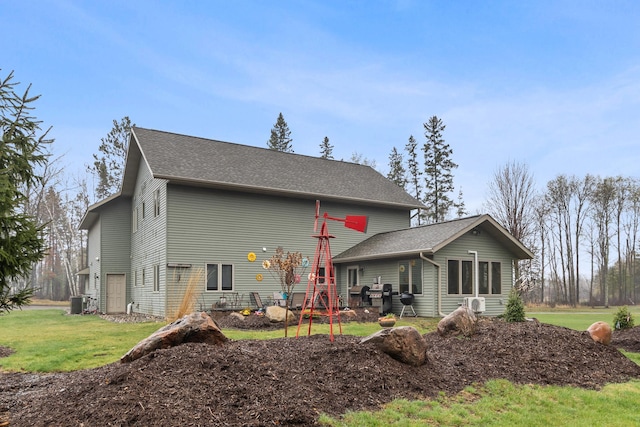 rear view of property featuring a lawn