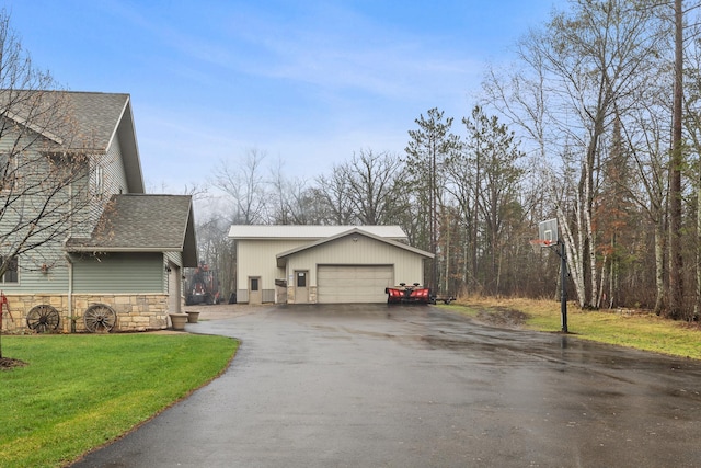 view of home's exterior featuring a garage and a lawn