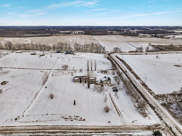 snowy aerial view featuring a rural view