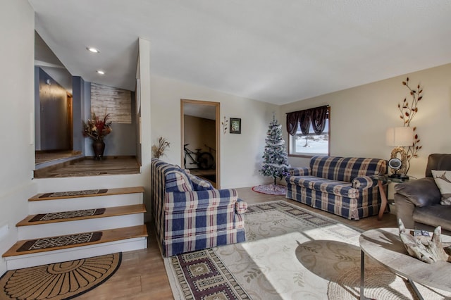 living room featuring vaulted ceiling and light hardwood / wood-style flooring